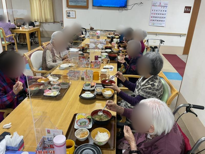 明るい食堂でお食事をする様子